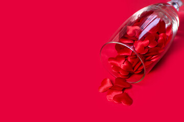 small hearts spill out of a glass red background