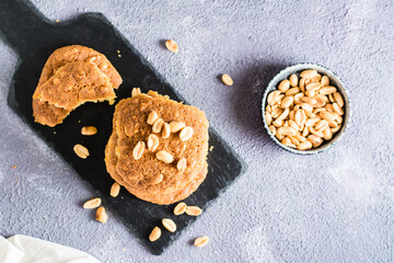 A stack of ready-to-eat fresh peanut cookies on a slate on a table. Homemade pastries. Top view