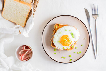 Homemade sandwich - croque madame on a plate on a light table. Top view