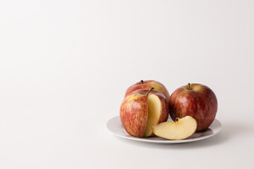 ripe red apples on a plate, white background