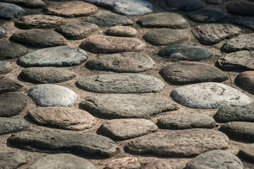 Stone pavement on street in old town closeup as stone background