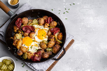 Potato hash brown with fried eggs and meat pastrami for breakfast branch