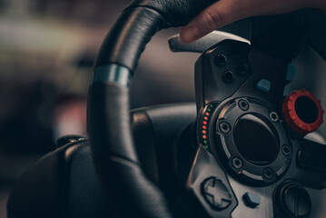 Technology, gaming, entertainment and people concept - young man playing car racing video game at...