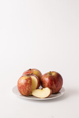 ripe red apples on a plate, white background