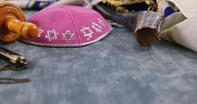 Jewish religious symbols with shofar tallit prayer book of Torah scrolls a pointer in the synagogue