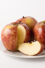 ripe red apples on a plate, white background