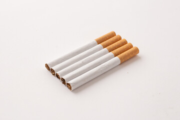 blonde cigarettes with filter on a white table, white background