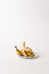 ripe bananas on a plate, white background