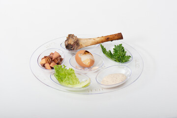Seder Plate transparent low-angle close-up view with six elements, on white background