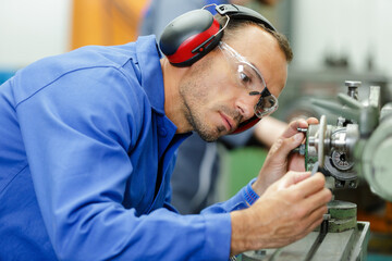 a man lubricates a machine