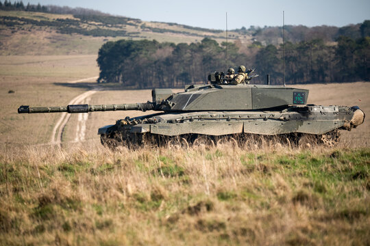 British army FV4034 Challenger 2 main battle tank with the commander and gunner directing action on a military exercise, Wiltshire UK