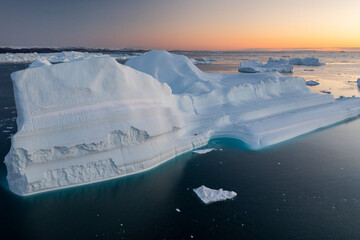 Enormes icebergs al atardecer desde punto de vista aéreo