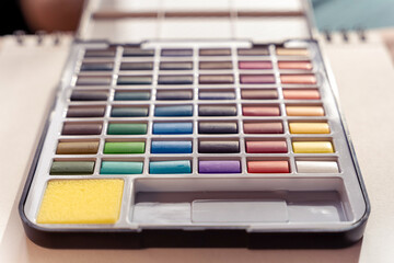 Aquarelle painting colors, pink blue red yellow watercolor palette hues, art supplies