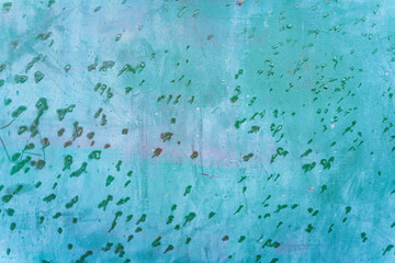 Turquoise blue aged weathered metal surface door with green rain water drops background texture