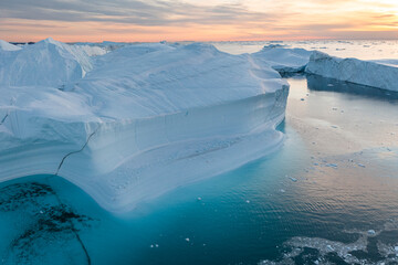 enormes icebergs de formas caprichosas flotando sobre el mar desde punto de vista aéreo