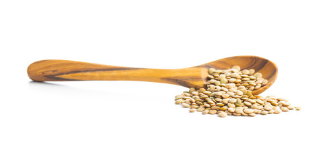 Uncooked brown lentils. Raw legume in wooden spoon isolated on white background.
