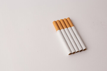 blonde cigarettes with filter on a white table, white background