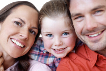 Smiling runs in the family. Close-up portrait of a young family.