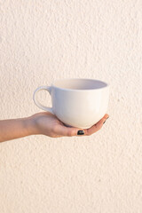 hand holding handmade ceramic cup