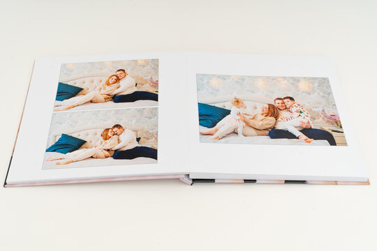 a book with photos of big family at home on a white background.