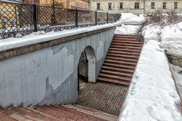 Arched entrance and side stairs to the city garden