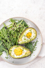 Healthy breakfast. Avocado stuffed with eggs on the table