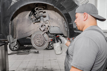Closeup disc brake of the vehicle for repair in garage.