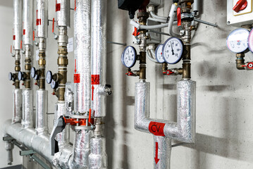 Barometers on pressure pipes, underground premises of the factory with heat and water distribution...