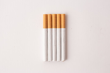 blonde cigarettes with filter on a white table, white background