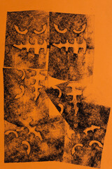 pastel chalk impression of halloween mask on orange paper