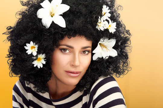 Woman with flowers in curly hair