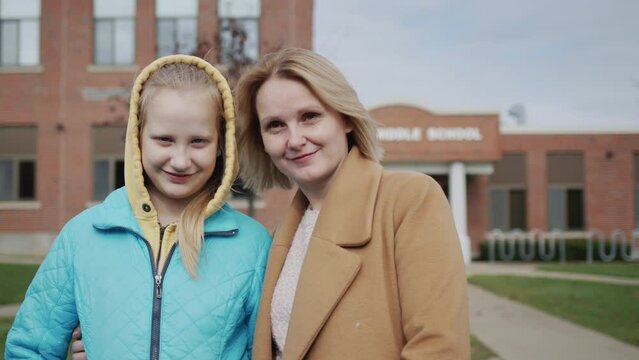 Portrait of a mother and daughter against the background of high school