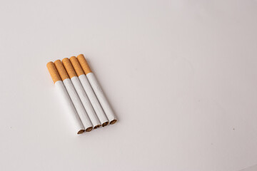 blonde cigarettes with filter on a white table, white background
