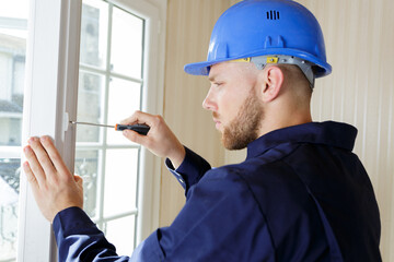 close-up of a repairmans hand fixing window