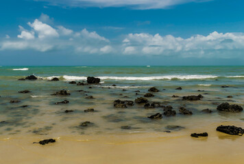 Linda praia com muitas pedras na areia localizada na Praia dos Espelhos, Bahia, chamada assim...