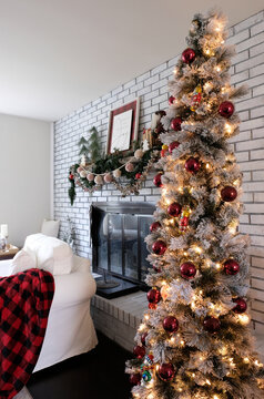 Vertical image of a holiday Christmas tree in a well decorated American home