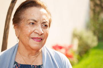 Close up portrait if senior woman smiling outdoors