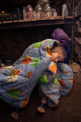 Ukrainian girl takes shelter in her basement.
