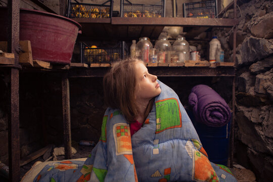Ukrainian girl takes shelter in her basement. - Powered by Adobe