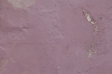 Red weathered painted wall background texture. Blue dirty peeled plaster wall with falling off flakes of paint. House wall eroded due to humidity and sunlight.