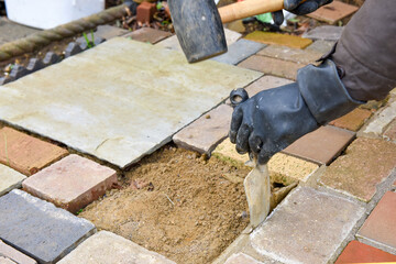 Laying a patio with stone concrete and tools of the trade