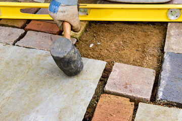 Laying a patio with stone concrete and tools of the trade