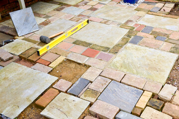 Laying a patio with stone concrete and tools of the trade