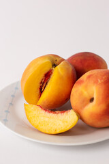 ripe peaches on a plate, white background