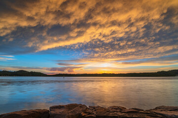 Sunrise by the bay with cumulonimbus clouds