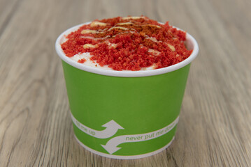 Delicious ice cream esquite topped with spicy crumbs and served in a take out order cup
