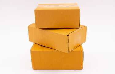 Three cardboard boxes are stacked on a white background, Online Selling Business Ideas.