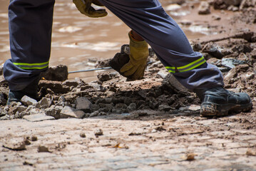 construction worker moving stone debris by hand