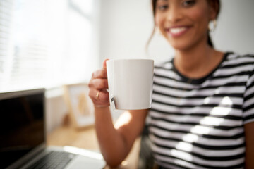 Did someone say tea time. Cropped shot of an unrecognizable woman enjoying a cup of tea while woking inside her studio.