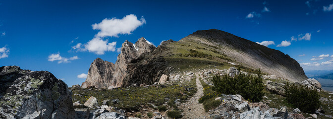 panorama of the Teton mountain range as a cloud passes overhead